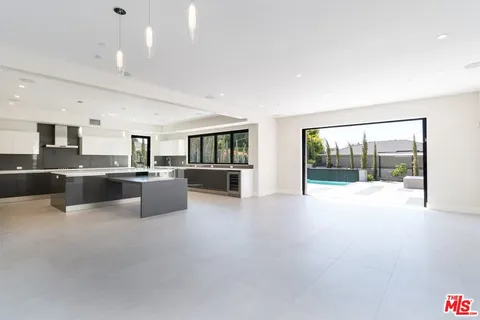 a large white kitchen with a large window