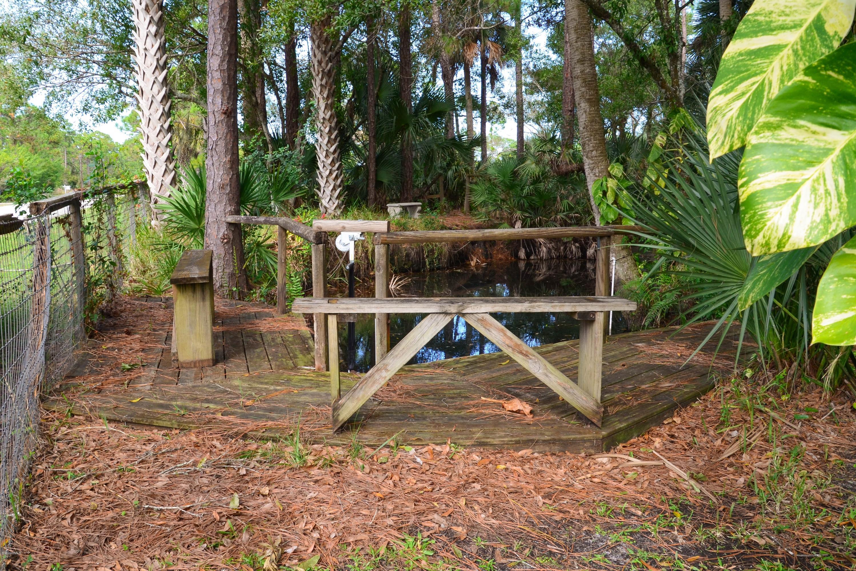 920 Atz Road Malabar, FL 32950 - Photo 38 of 42 Pond Dock with water flow lock