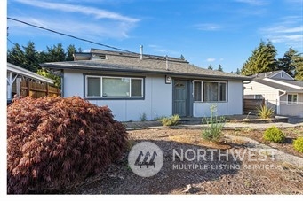 3306 Northeast 7th Place Renton, WA 98056 - Photo 1 of 11 a view of a house with a backyard