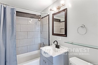 3306 Northeast 7th Place Renton, WA 98056 - Photo 7 of 11 a bathroom with a sink toilet vanity and shower