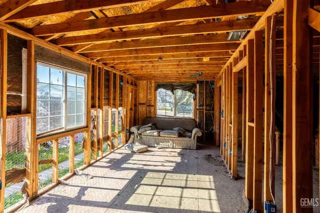 a view of a patio with table and chairs with wooden floor and fence