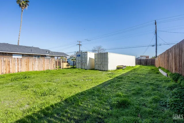 a backyard of a house with plants and outdoor seating