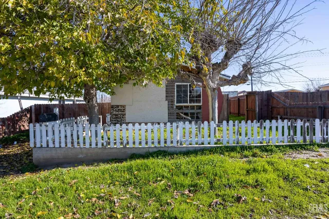 a view of a house with wooden fence
