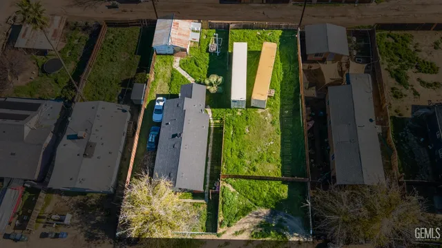 an aerial view of residential house with outdoor space and trees