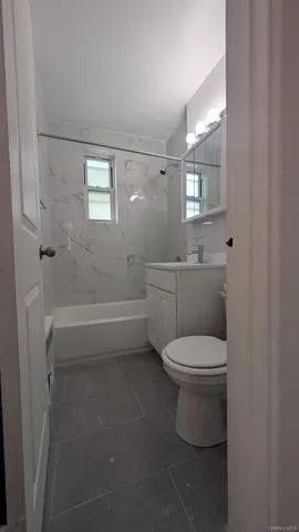 a bathroom with a toilet a sink and bathtub