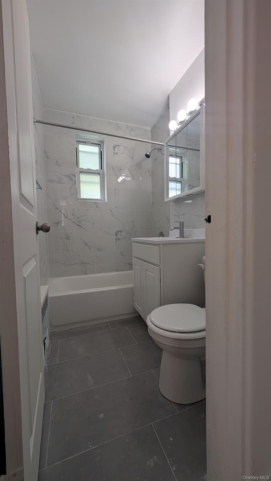 32-06 200th Street, Unit 3F Queens, NY 11361 - Photo 1 of 3 a bathroom with a toilet a sink and bathtub