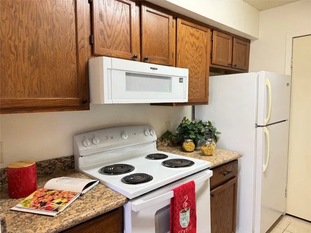 a kitchen with a stove a refrigerator and a sink