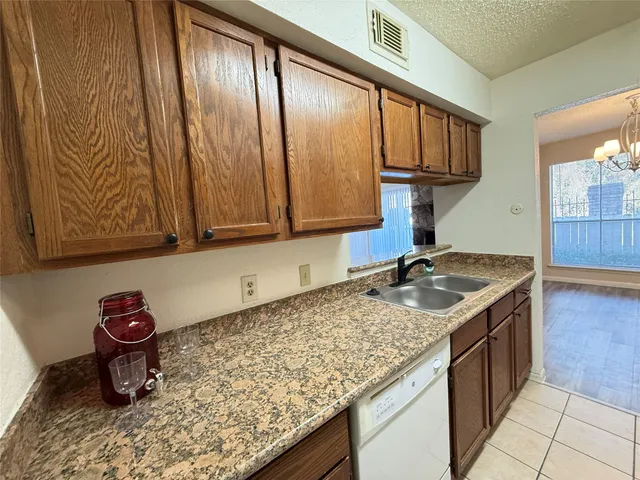 a kitchen with a stove a sink and cabinets