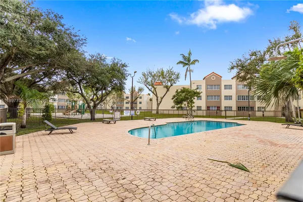 a swimming pool with outdoor seating and yard