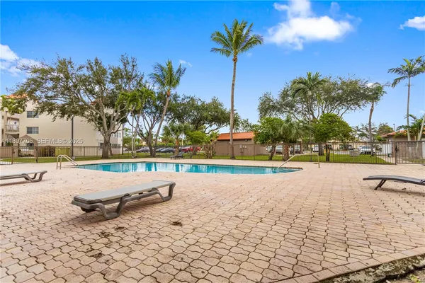 a view of swimming pool with outdoor seating and plants
