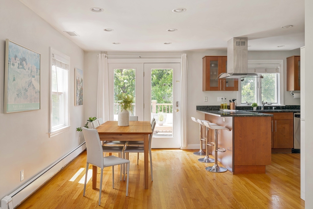 a dining room with furniture and wooden floor