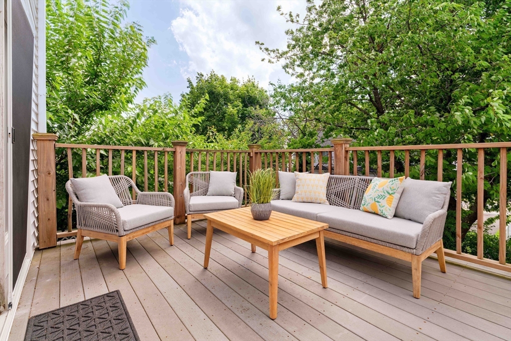 41 Wilson Avenue, Unit 41 Watertown, MA 02472 - Photo 2 of 22 a balcony with wooden floor and outdoor seating