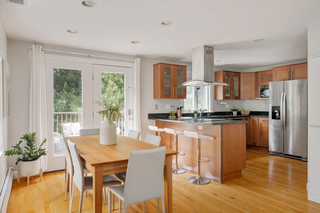 41 Wilson Avenue, Unit 41 Watertown, MA 02472 - Photo 4 of 22 a kitchen with granite countertop white cabinets and stainless steel appliances