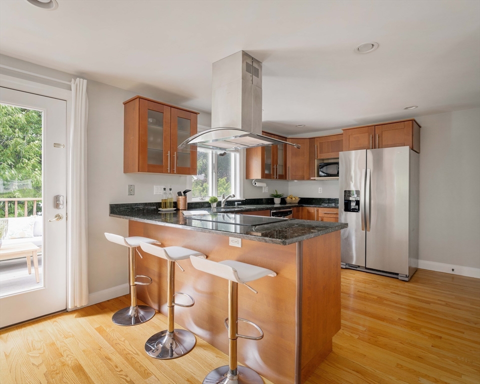 41 Wilson Avenue, Unit 41 Watertown, MA 02472 - Photo 5 of 22 a kitchen with stainless steel appliances granite countertop a sink and a refrigerator