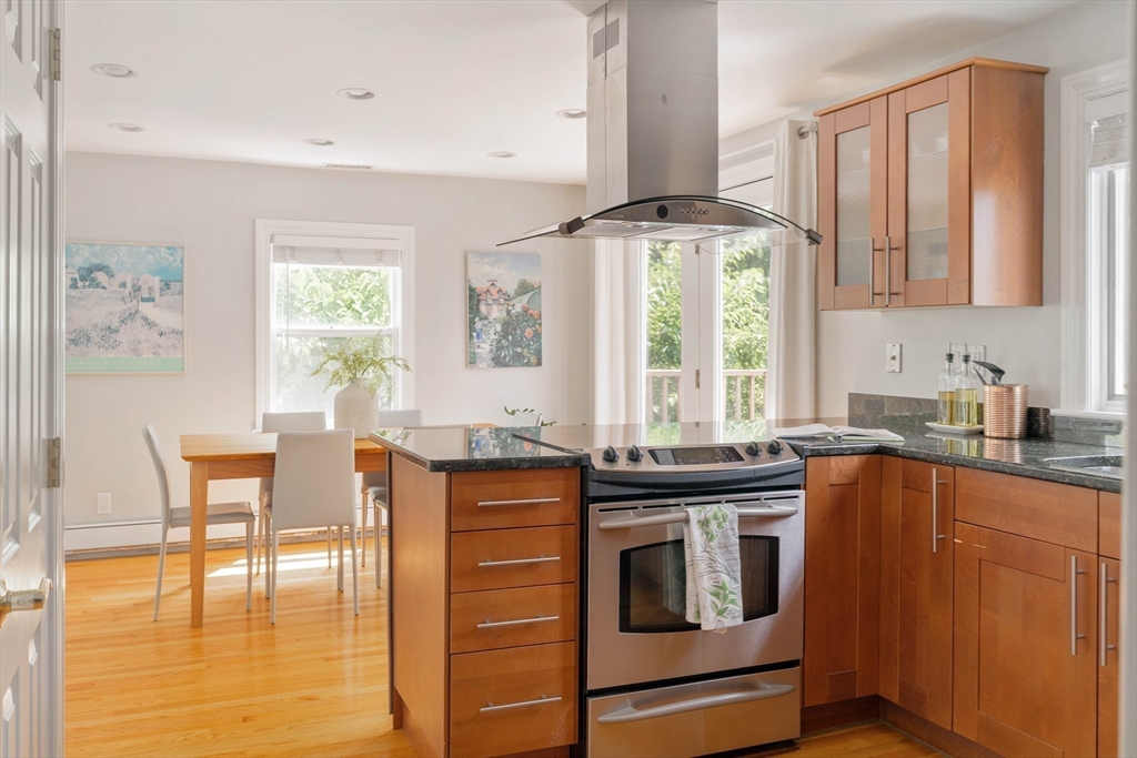 41 Wilson Avenue, Unit 41 Watertown, MA 02472 - Photo 7 of 22 a kitchen with stainless steel appliances granite countertop a stove a sink and a refrigerator