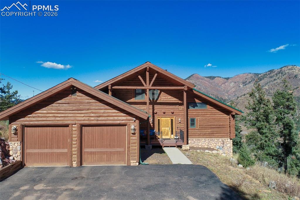 9110 Mountain Road Cascade, CO 80809 - Photo 40 of 49 a front view of a house with a yard