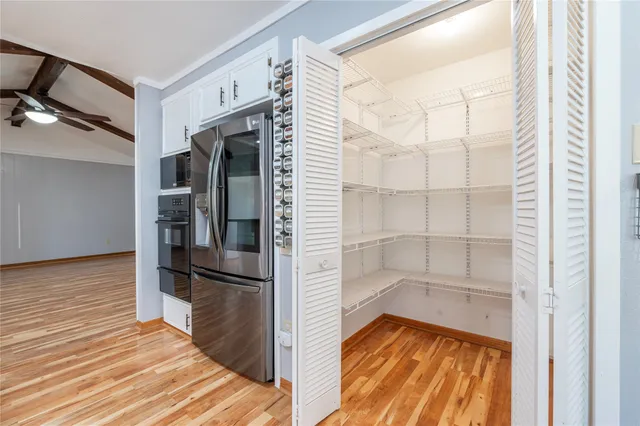 a white stove top oven sitting inside of a kitchen