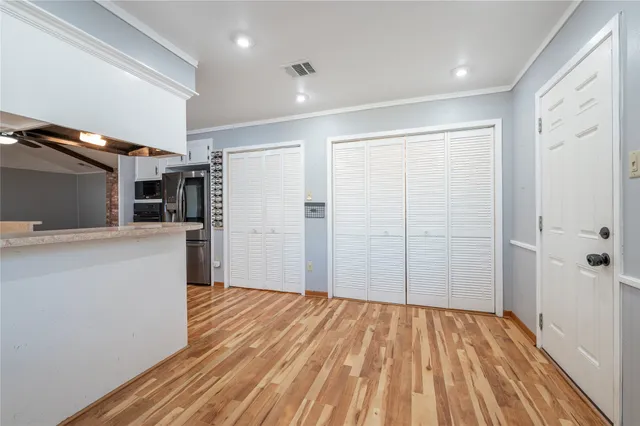 a view of empty room with wooden floor