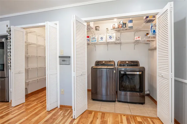 an empty room with wooden floor and door