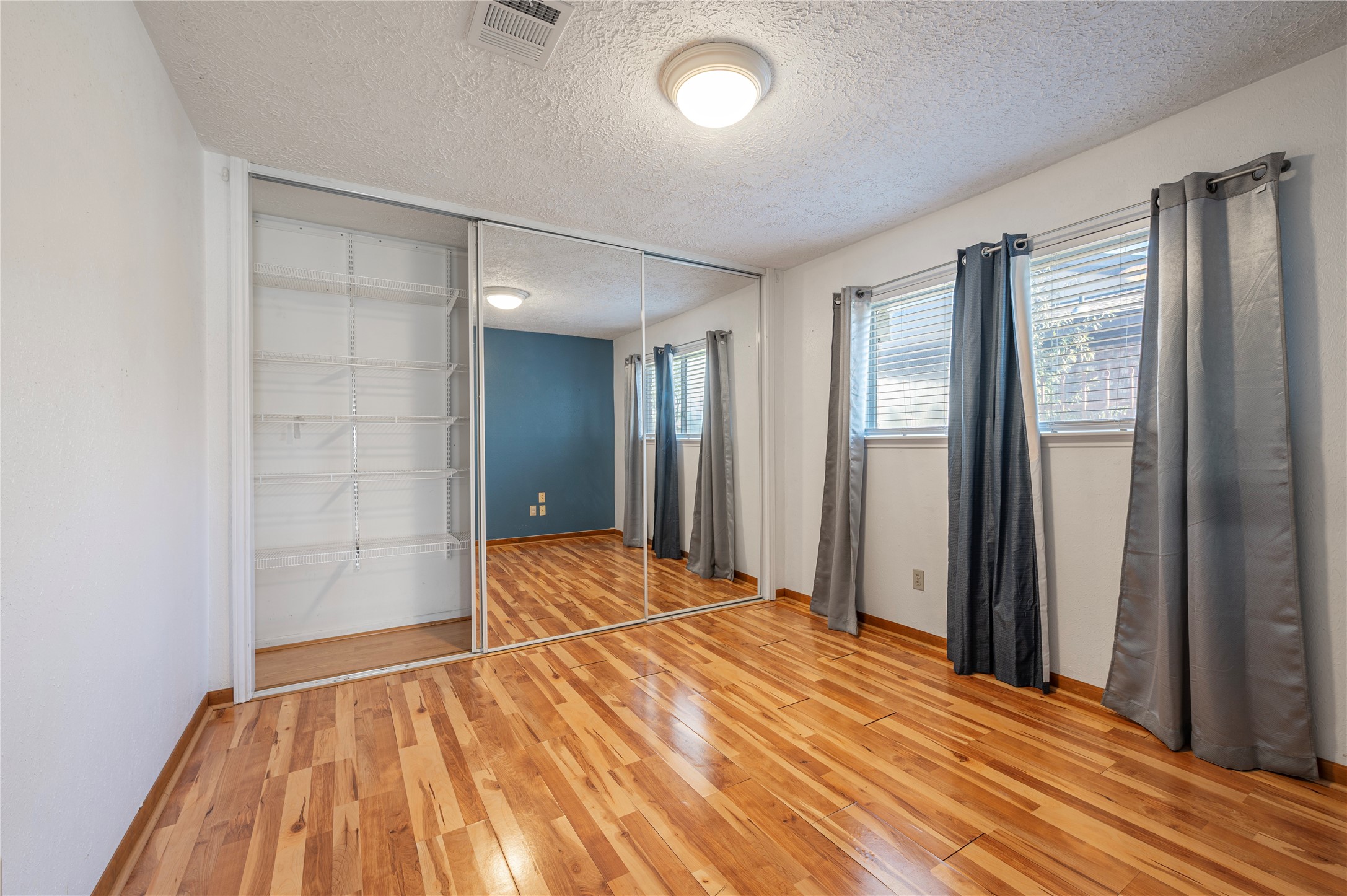 13727 Oleoke Lane Houston, TX 77015 - Photo 21 of 42 an empty room with closet and wooden floor