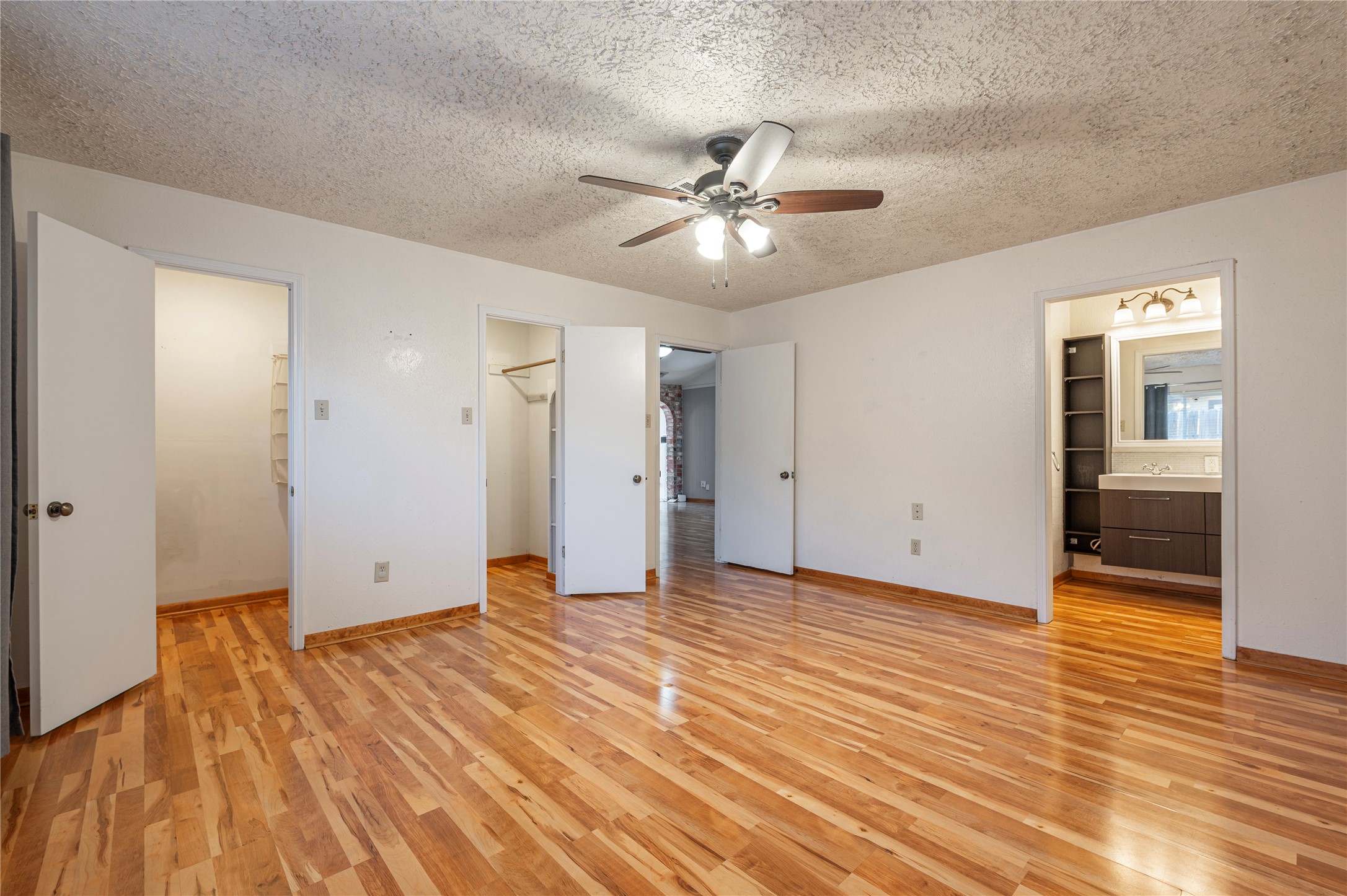 13727 Oleoke Lane Houston, TX 77015 - Photo 23 of 42 an empty room with wooden floor and ceiling fan
