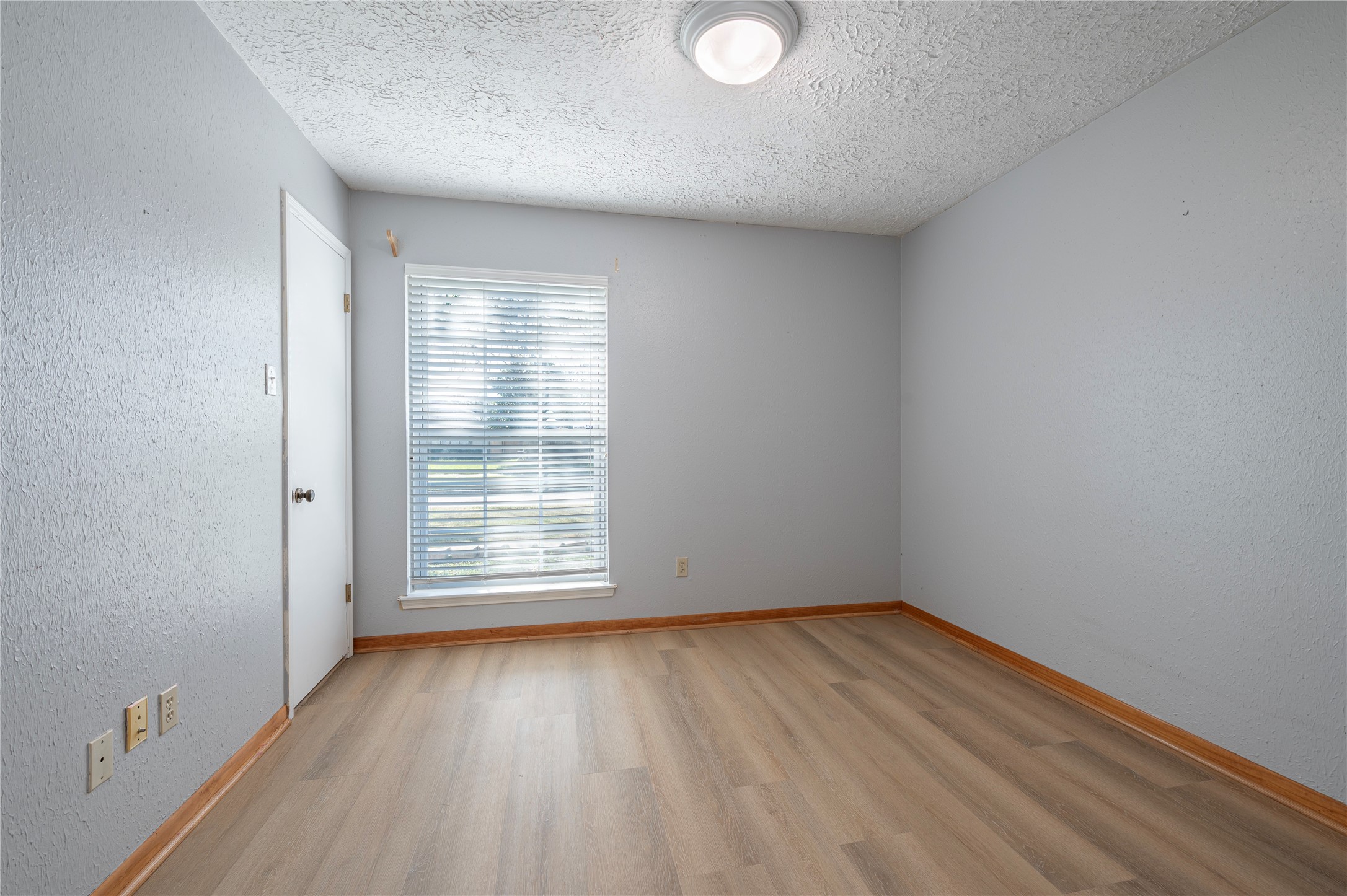 13727 Oleoke Lane Houston, TX 77015 - Photo 30 of 42 wooden floor in an empty room with a window