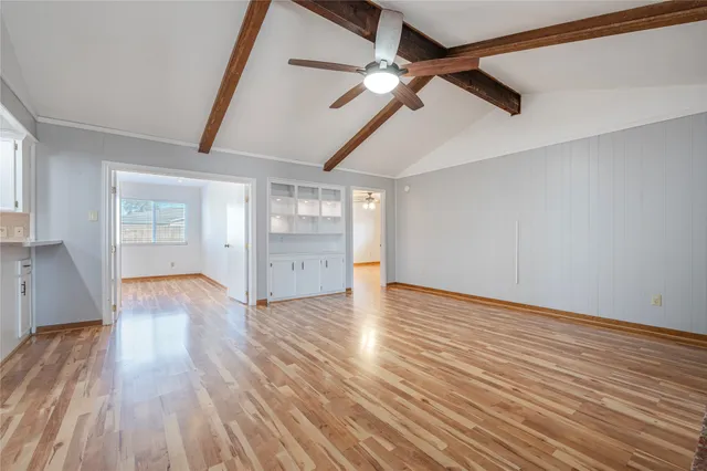 a view of a livingroom with wooden floor and a fireplace