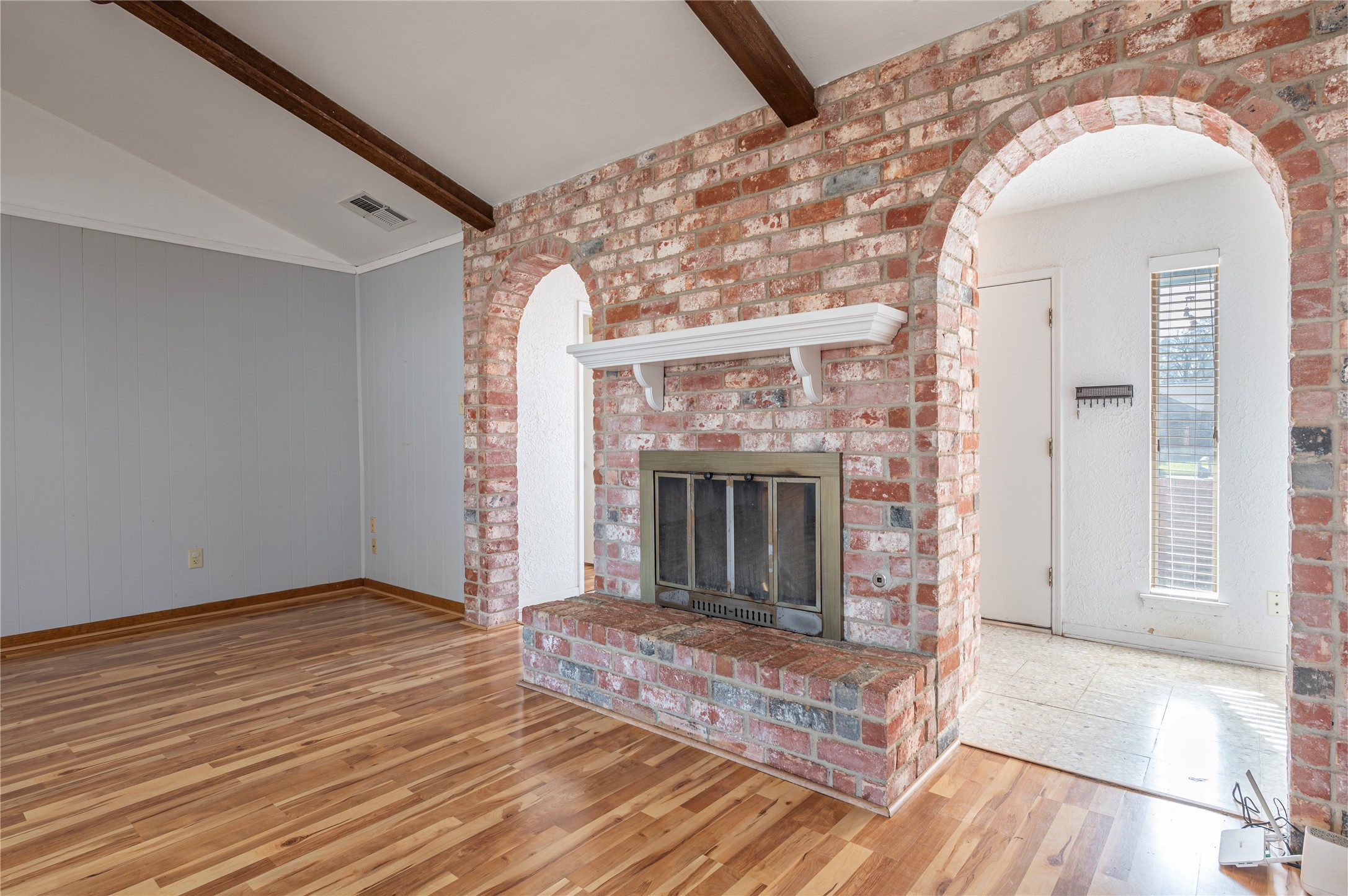 13727 Oleoke Lane Houston, TX 77015 - Photo 10 of 42 a view of a livingroom with wooden floor and a fireplace