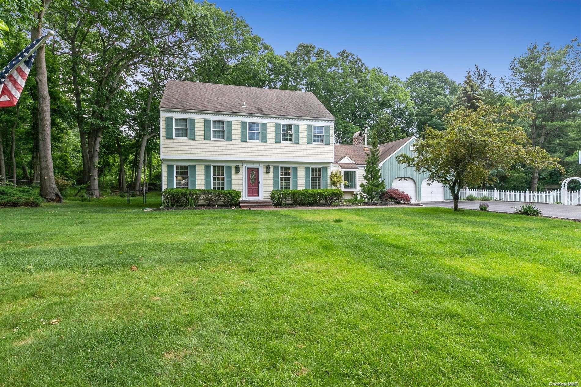 5 Trappers Path Wading River, NY 11792 - Photo 1 of 1 a front view of a house with a garden