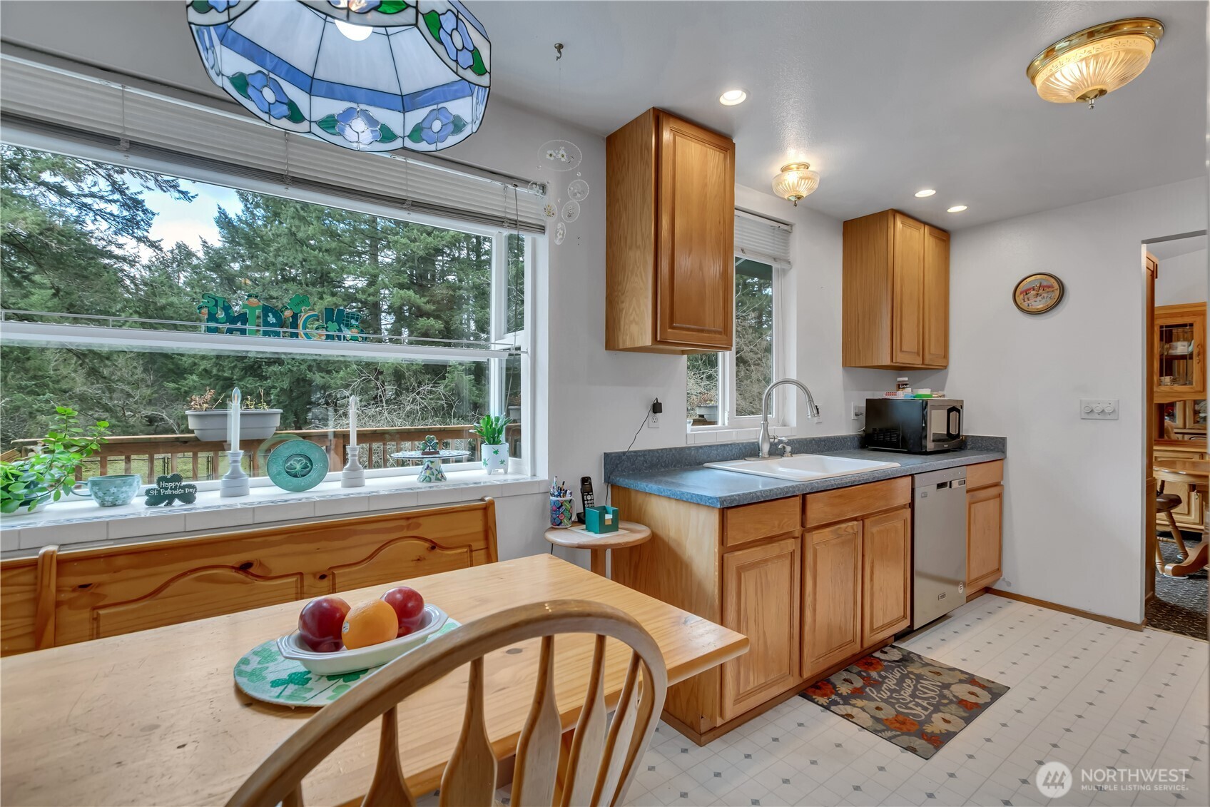 7316 Eustis Hunt Road Spanaway, WA 98387 - Photo 13 of 32 a kitchen with stainless steel appliances granite countertop a stove a sink and a dining table with garden view