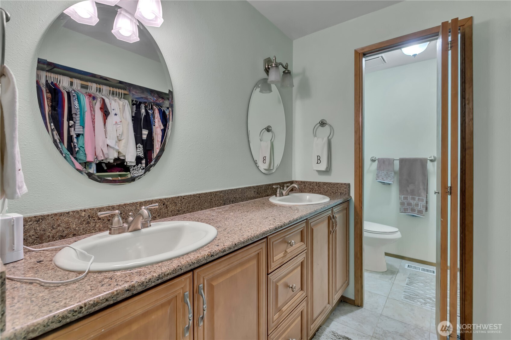 7316 Eustis Hunt Road Spanaway, WA 98387 - Photo 16 of 32 a bathroom with a granite countertop sink and a mirror