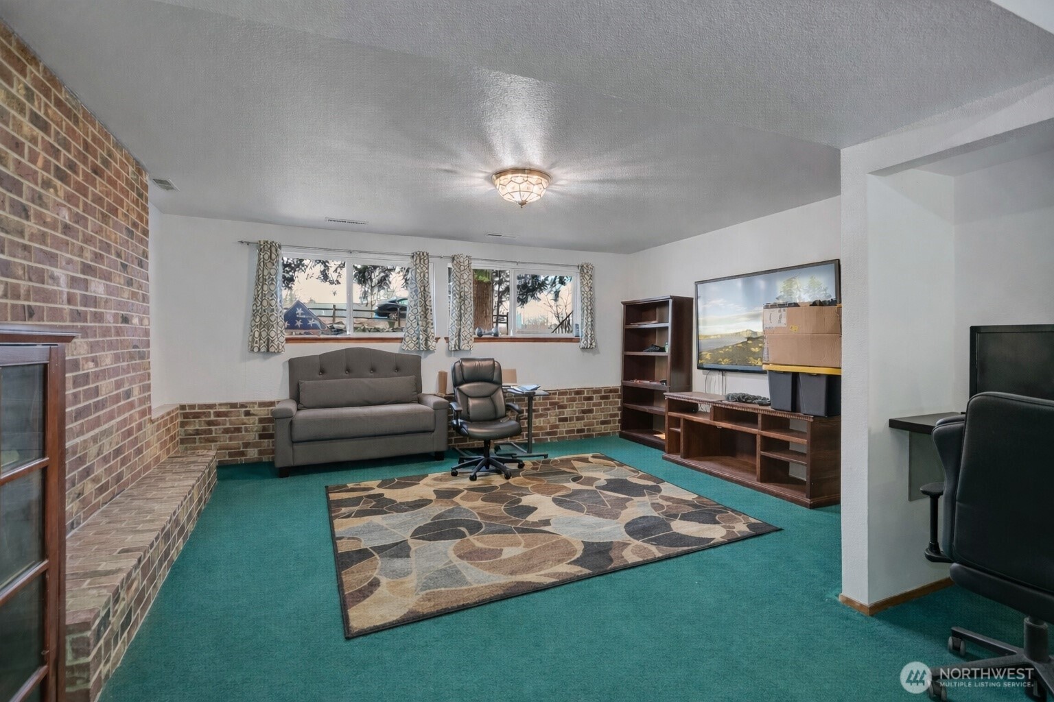 7316 Eustis Hunt Road Spanaway, WA 98387 - Photo 21 of 32 a living room with furniture and a flat screen tv