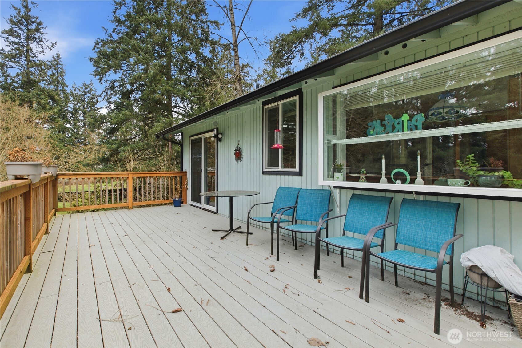 7316 Eustis Hunt Road Spanaway, WA 98387 - Photo 26 of 32 a view of house with deck outdoor seating and hardwood floor