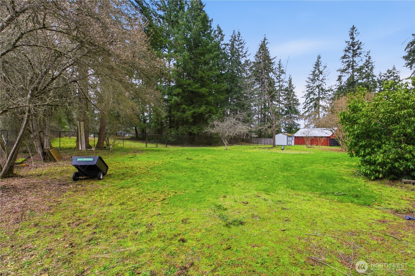 7316 Eustis Hunt Road Spanaway, WA 98387 - Photo 27 of 32 a garden with trees in the background