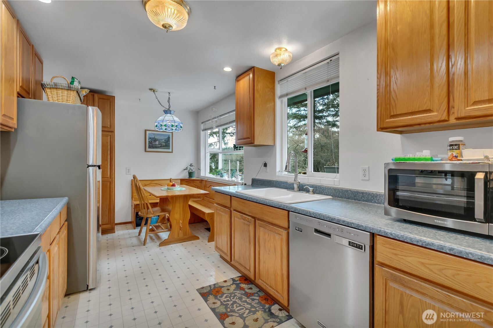 7316 Eustis Hunt Road Spanaway, WA 98387 - Photo 7 of 32 a kitchen with stainless steel appliances granite countertop a sink stove and refrigerator