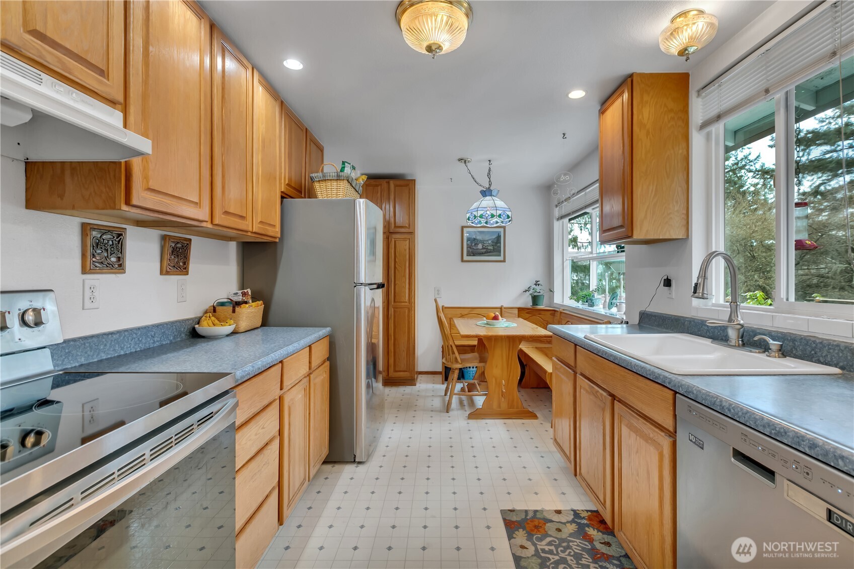 7316 Eustis Hunt Road Spanaway, WA 98387 - Photo 8 of 32 a kitchen with stainless steel appliances granite countertop a sink a stove and a refrigerator