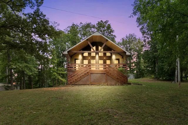 a front view of a house with yard and green space