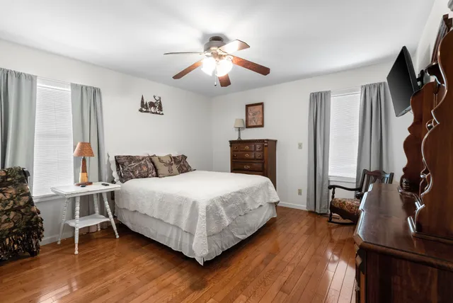 a spacious bedroom with a bed and a chandelier