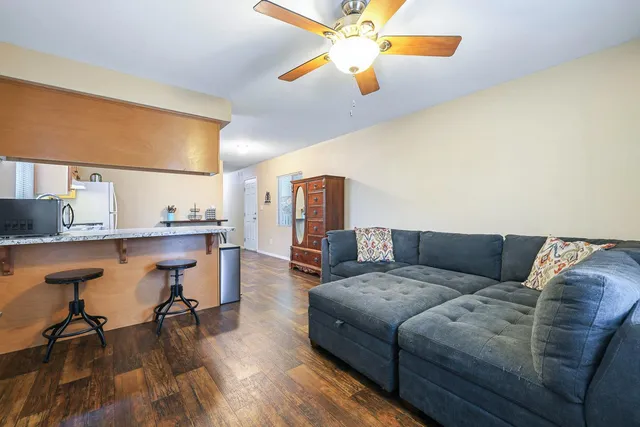 a living room with furniture and kitchen view