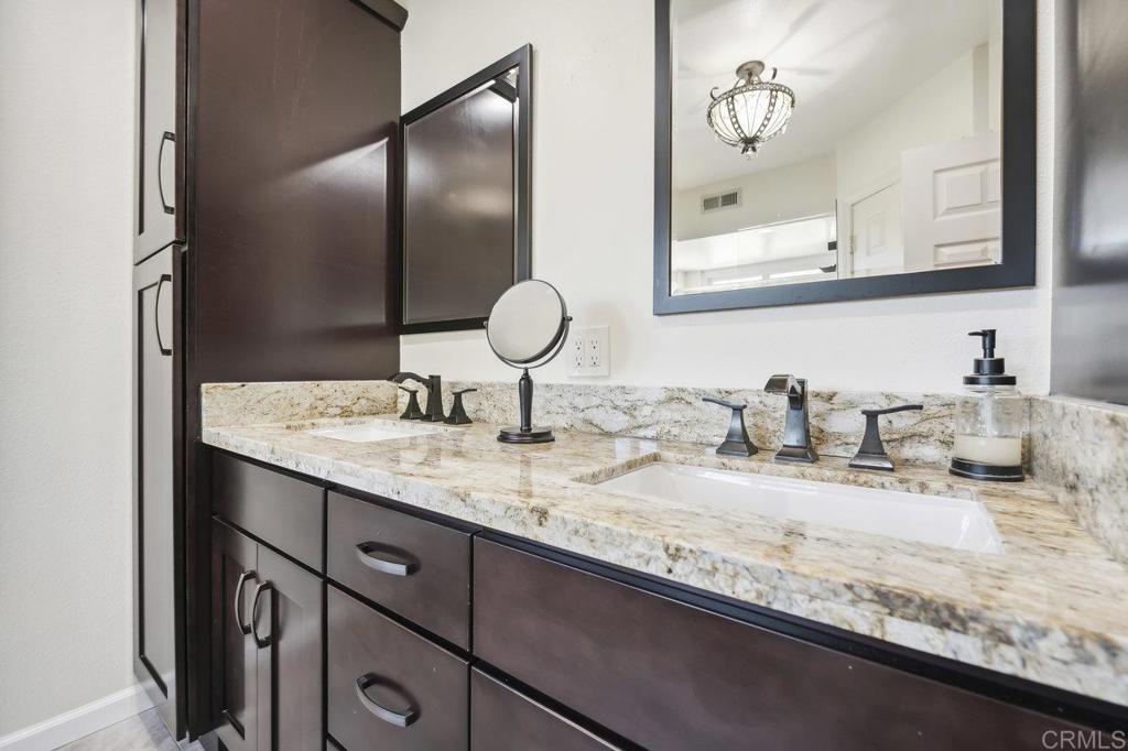 430 Silver Shadow Drive San Marcos, CA 92078 - Photo 23 of 36 a bathroom with a granite countertop sink and a mirror