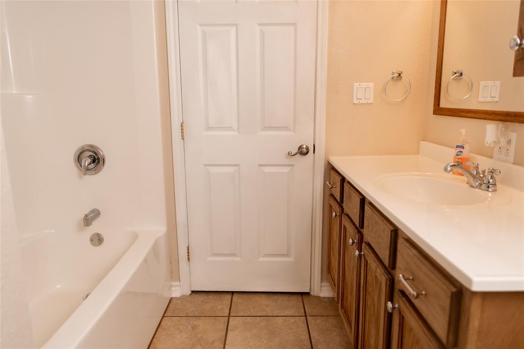 5215 Highway 7 Center, TX 75935 - Photo 14 of 37 Bathroom featuring vanity, light tile patterned floors, and washtub / shower combination