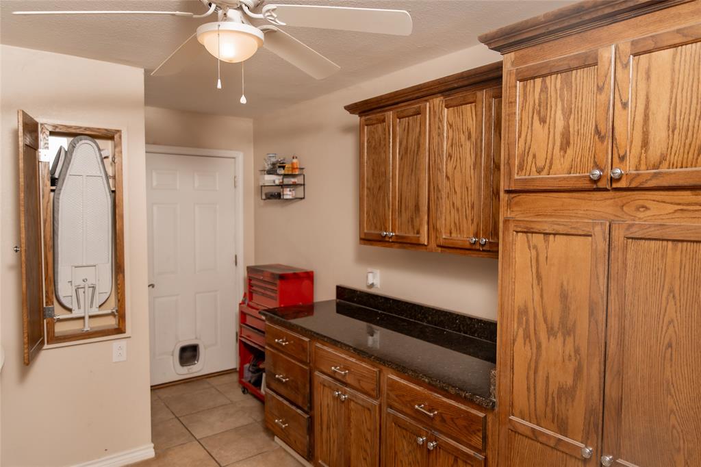5215 Highway 7 Center, TX 75935 - Photo 19 of 37 Laundry area with ceiling fan and light tile patterned floors