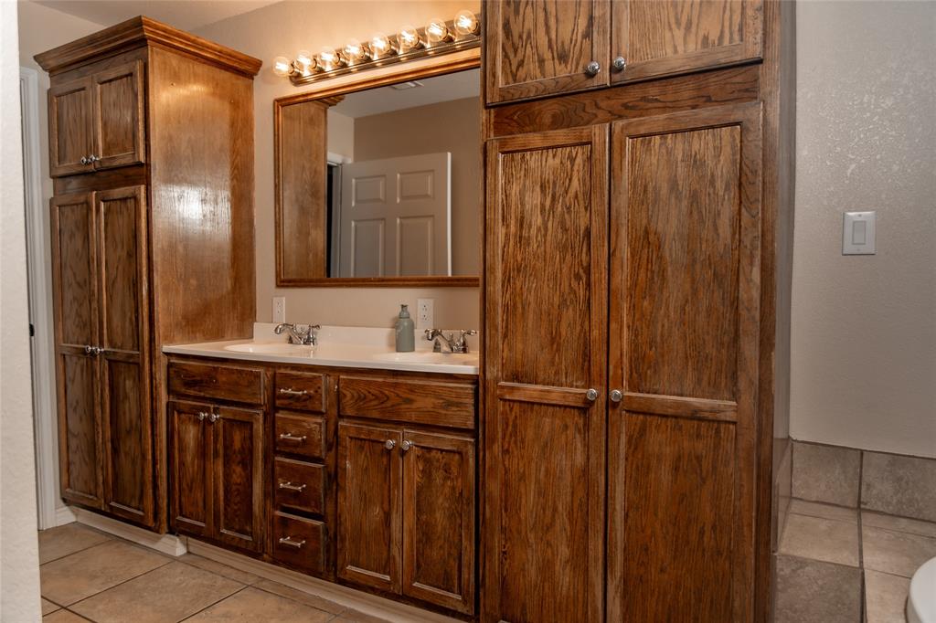 5215 Highway 7 Center, TX 75935 - Photo 24 of 37 Bathroom with double vanity and light tile patterned floors