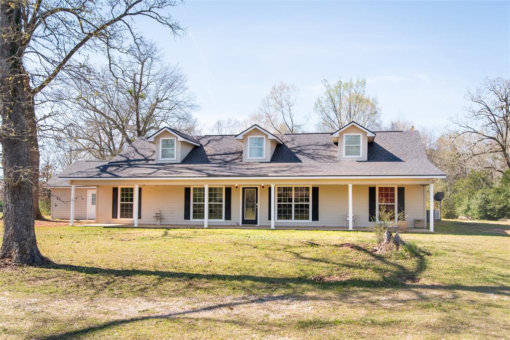 5215 Highway 7 Center, TX 75935 - Photo 3 of 37 Cape cod house with covered porch, a front yard, and a shingled roof