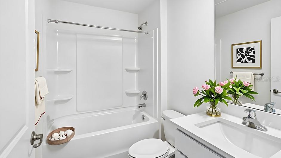 4597 Southwest 88 Place Ocala, FL 34476 - Photo 8 of 12 a bathroom with a sink a toilet and a bathtub