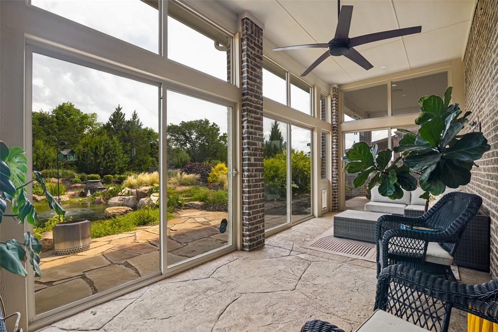 388 Bethany Road Sunnyvale, TX 75182 - Photo 34 of 40 Enclosed patio featuring a stamped concrete floor, brick columns, and expansive sliding doors