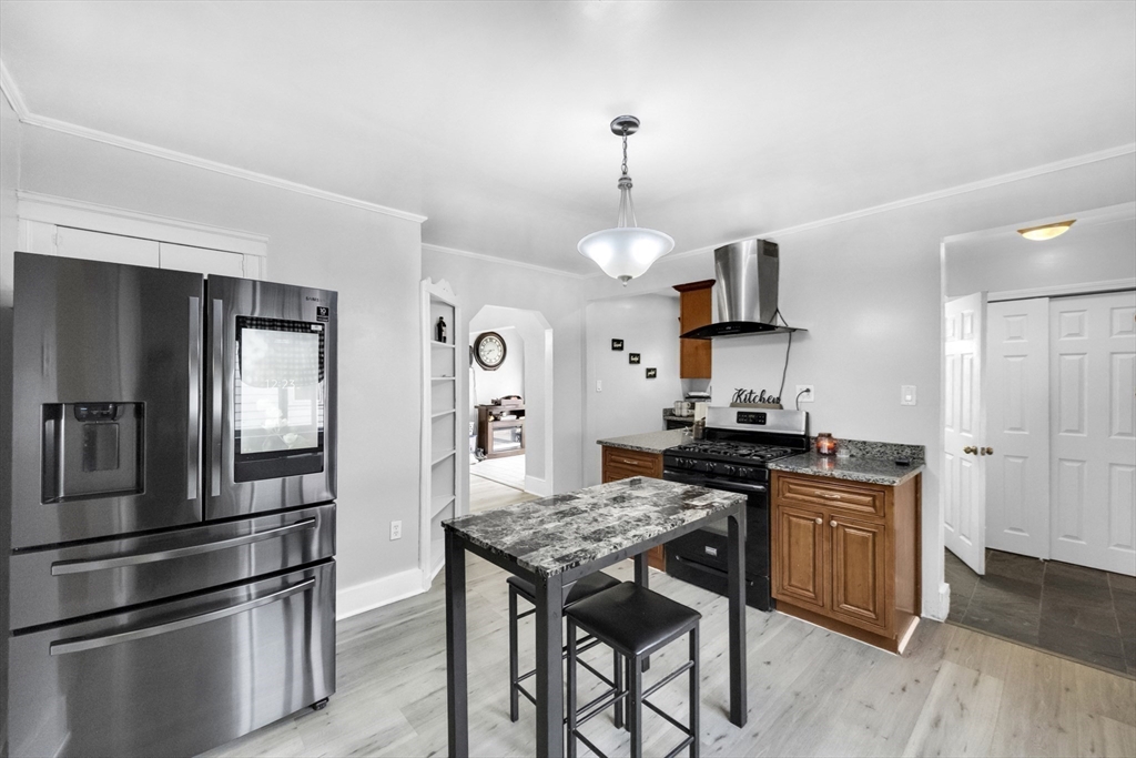 69 Eureka Street Worcester, MA 01603 - Photo 25 of 37 a kitchen with stainless steel appliances granite countertop a stove a refrigerator and a sink