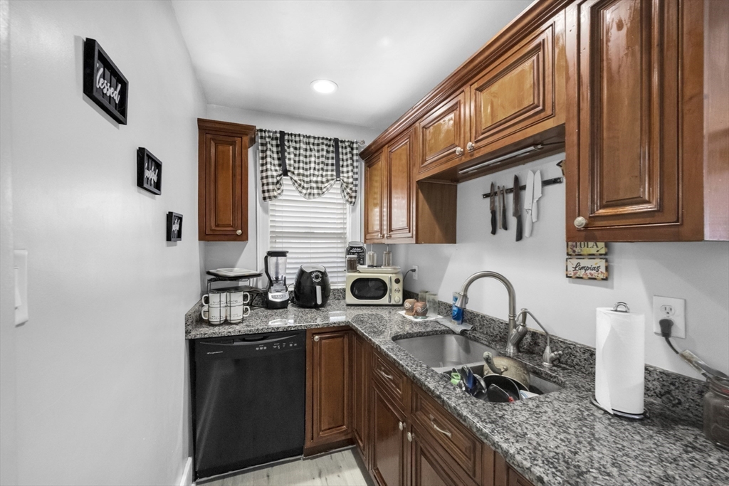 69 Eureka Street Worcester, MA 01603 - Photo 26 of 37 a kitchen with stainless steel appliances granite countertop a sink stove and cabinets