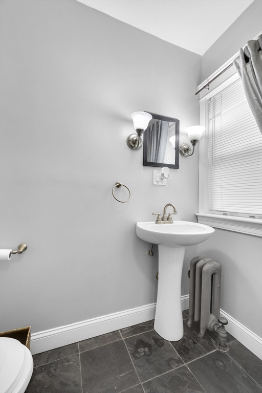 69 Eureka Street Worcester, MA 01603 - Photo 27 of 37 a bathroom with a sink toilet and mirror