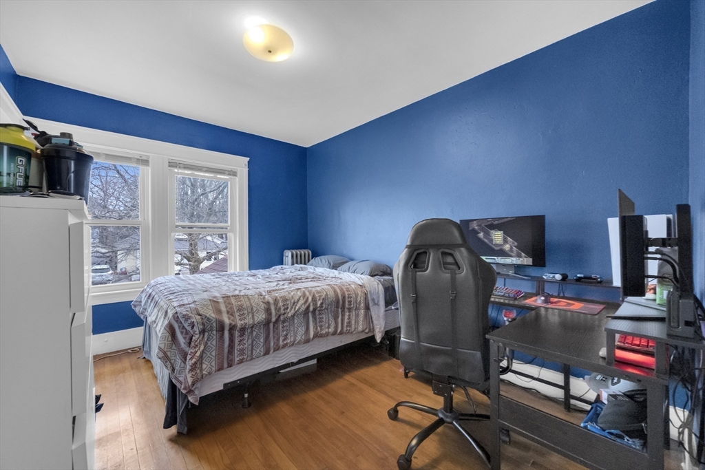69 Eureka Street Worcester, MA 01603 - Photo 30 of 37 a bedroom with a bed chair and a window